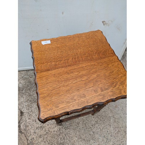 672 - A vintage oak side table with barley twist legs