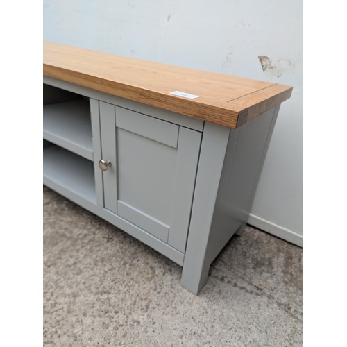 648 - A modern television stand with an oak effect top and painted base