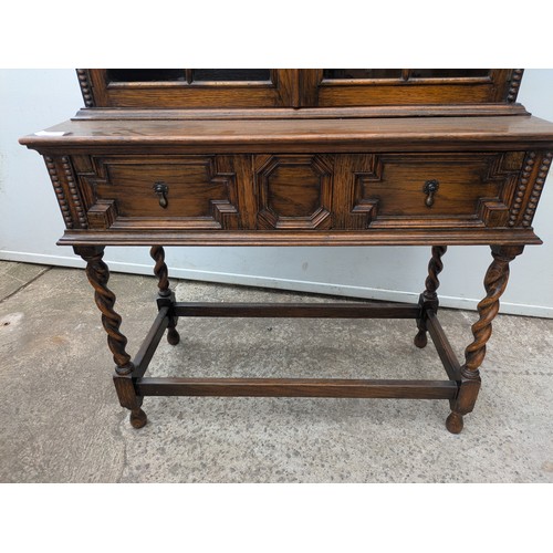 650 - A vintage oak glass fronted display cabinet with underlying drawers - key included