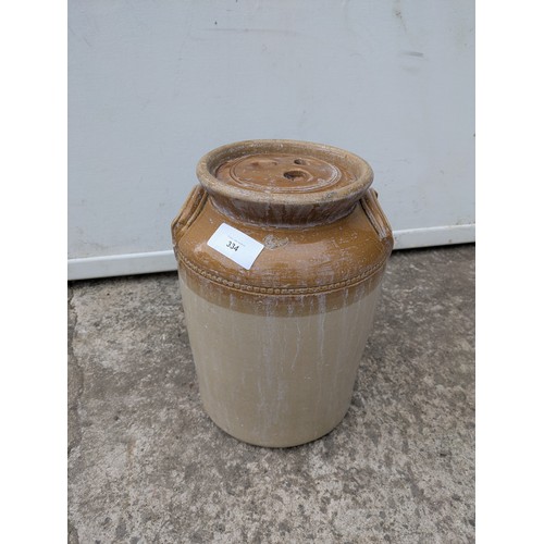 334 - An antique stoneware jug with lid