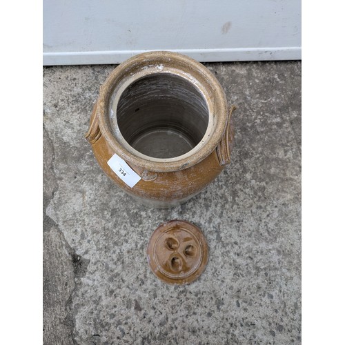 334 - An antique stoneware jug with lid