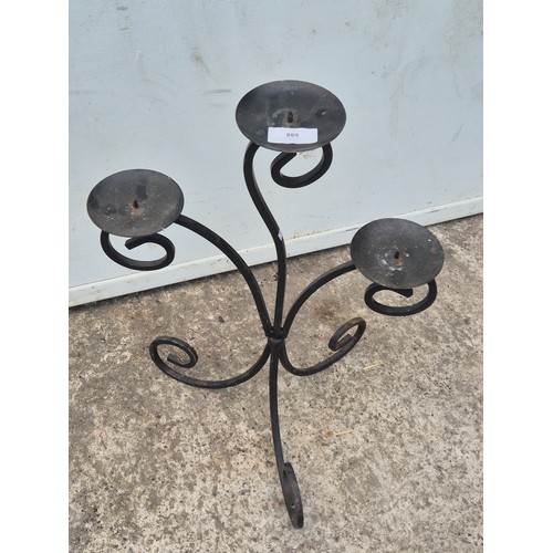 688 - A wrought iron 2 branch candlestick holder