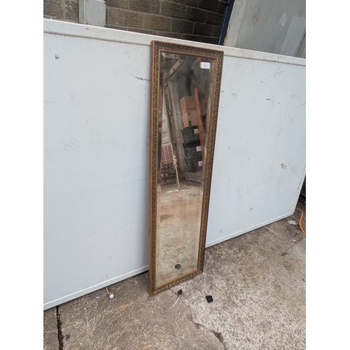 697 - A bevelled edge upright dressing mirror in gold gilt frame