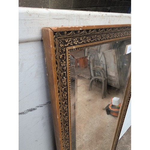 697 - A bevelled edge upright dressing mirror in gold gilt frame