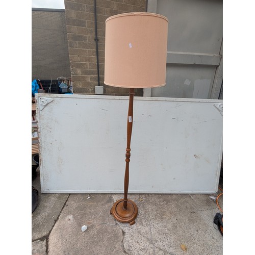702 - A vintage mahogany floor standing lamp