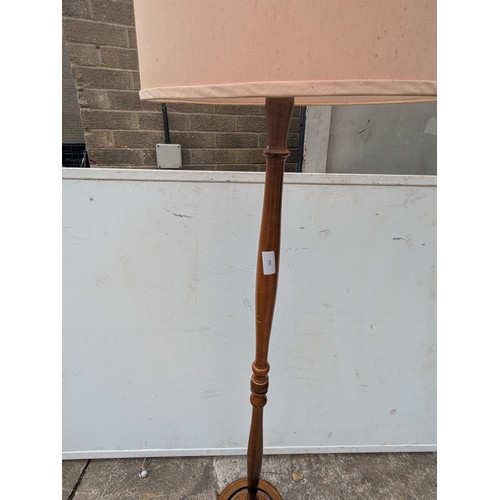 702 - A vintage mahogany floor standing lamp