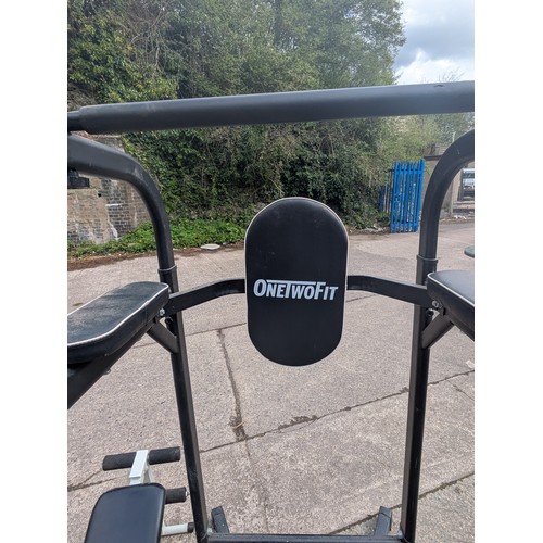 363 - A OmeTwoFit pull up and dip station with a collapsible bench