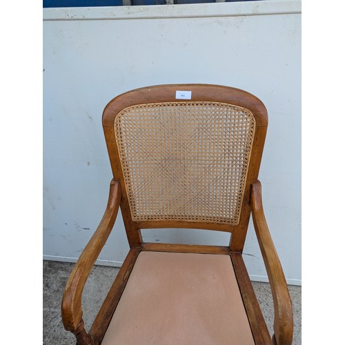 403 - A vintage wicker backed arm chair