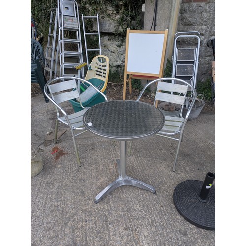 309 - A polished steel outdoor bistro table with 2 chairs