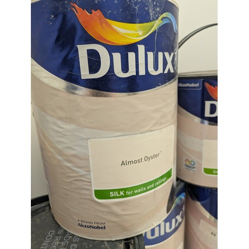45 - A large selection of Dulux almost oyster 5 litre and 2.5 litre tins of paint