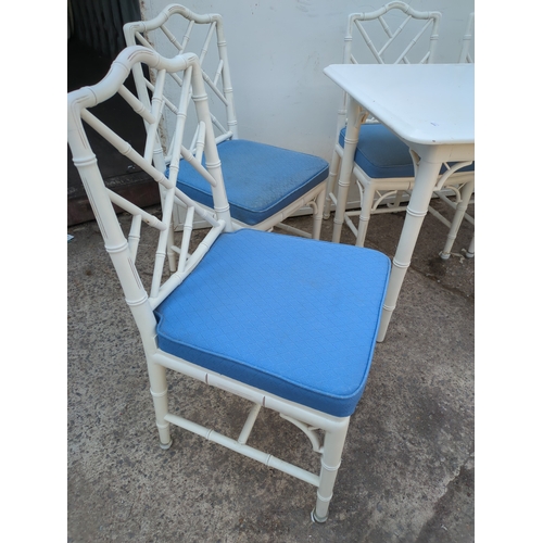 603 - A modern painted dining table with 4 matching bamboo style chairs