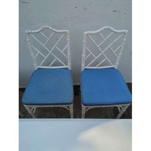 603 - A modern painted dining table with 4 matching bamboo style chairs