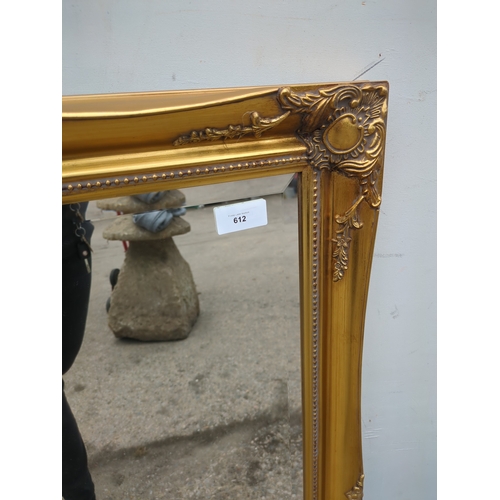 612 - A Bevelled edge wall hanging mirror in an ornate Gold Gilt frame