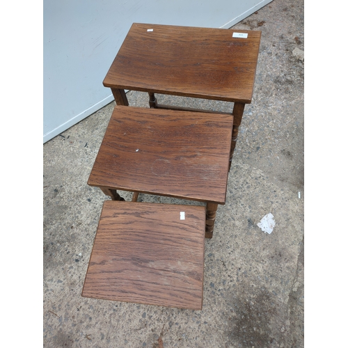 614 - A nest of 3 oak tables