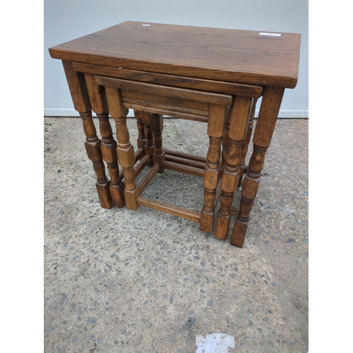 614 - A nest of 3 oak tables