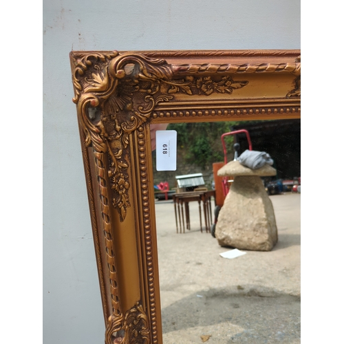 618 - A wall hanging mirror in an ornate Gold Gilt frame
