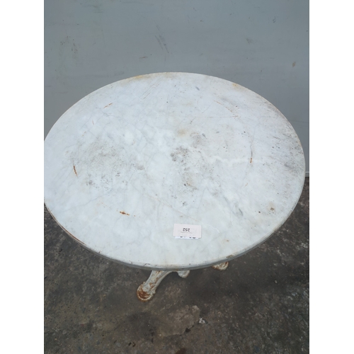 252 - A garden table with a cast iron base and marble top
