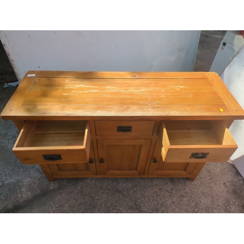700 - An oak side unit with 2 drawers and cupboard space