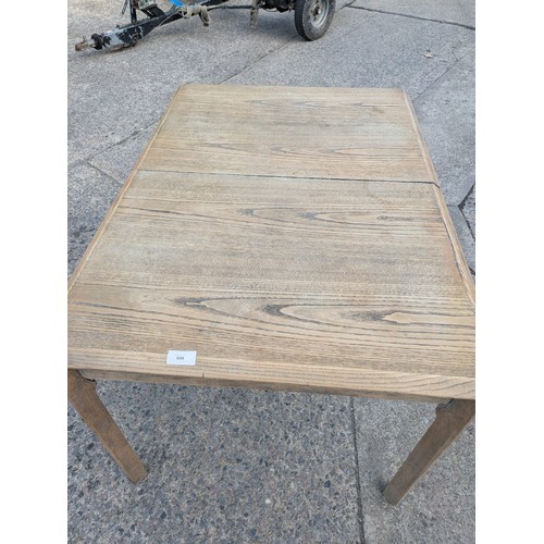 699 - An extending oak dining table