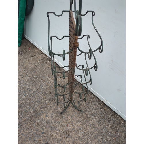 451 - A wrought iron and wicker bottle rack
