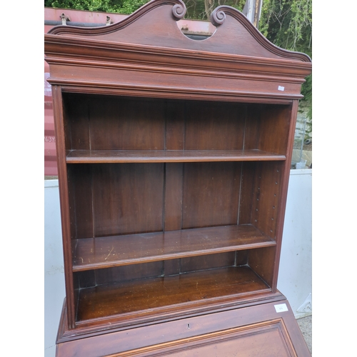 474 - An antique mahogany bureau with shelving unit