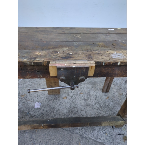 19 - A vintage pine workbench with vise