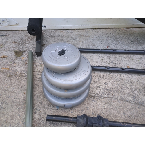 20 - A workout bench with a selection of weights