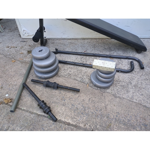 20 - A workout bench with a selection of weights