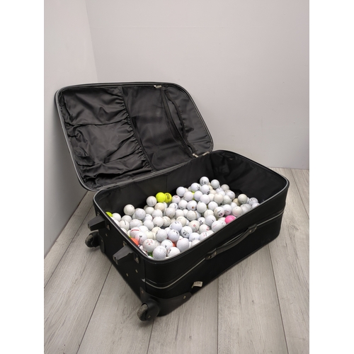 202 - Lot of golf balls in suitcase