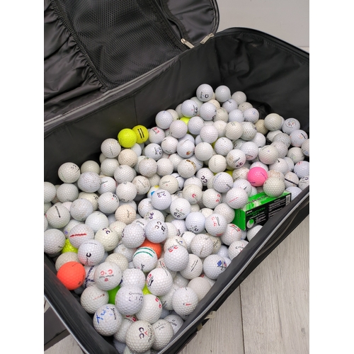 202 - Lot of golf balls in suitcase