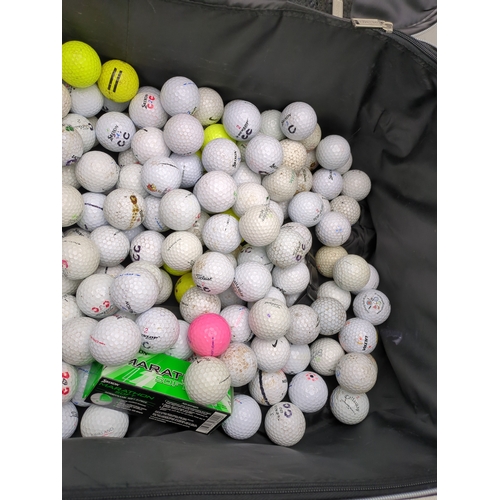 202 - Lot of golf balls in suitcase