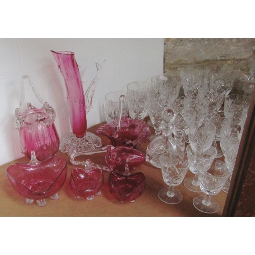 128 - A mixed collection of cut and cranberry glassware to include various wine and sherry glasses,tumbler... 