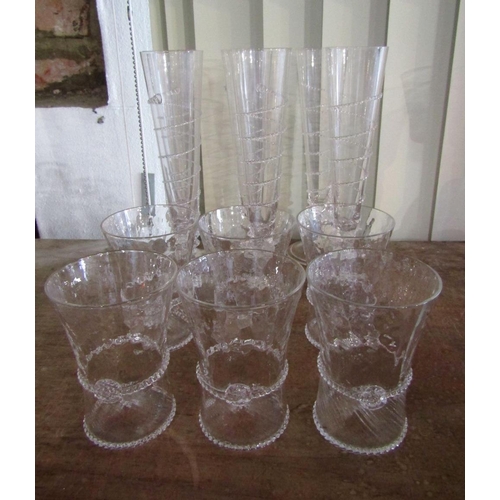 132 - Set of six Juliska champagne flutes with applied glass spiral detail,23cm high,together with a furth... 