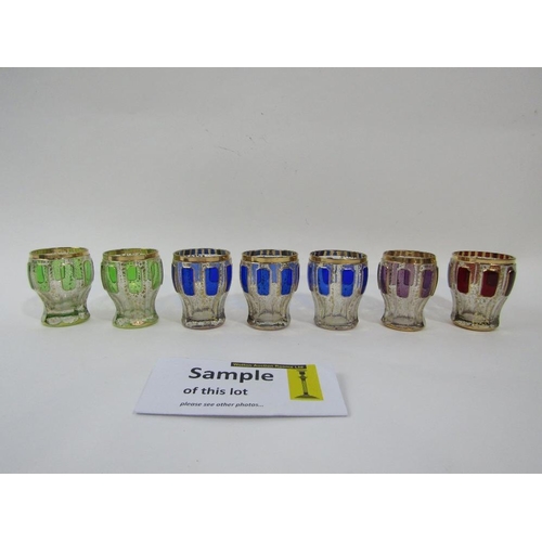 133 - Set of seven bohemian glass short drinking glasses with embossed coloured panels and gilt decoration... 