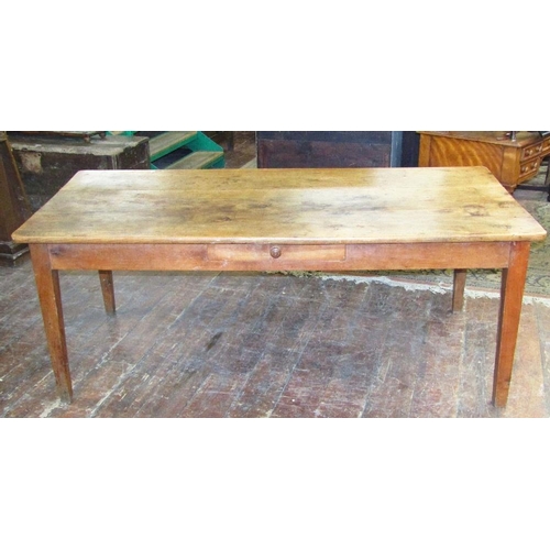 1510 - An early 19th century fruitwood dining table the heavy plank top raised on four square taper support... 