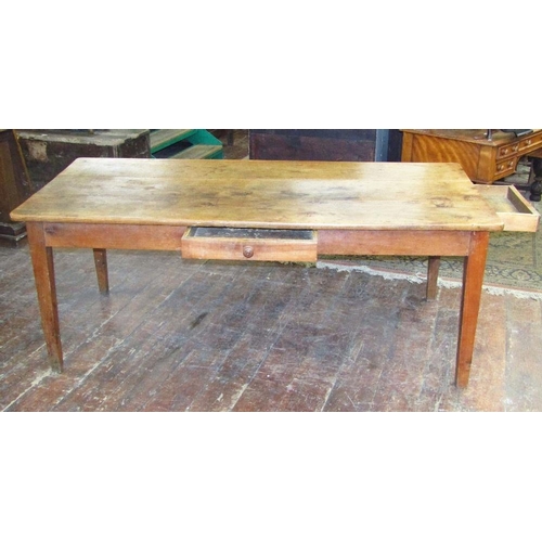 1510 - An early 19th century fruitwood dining table the heavy plank top raised on four square taper support... 