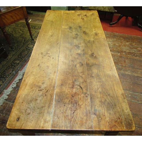 1510 - An early 19th century fruitwood dining table the heavy plank top raised on four square taper support... 