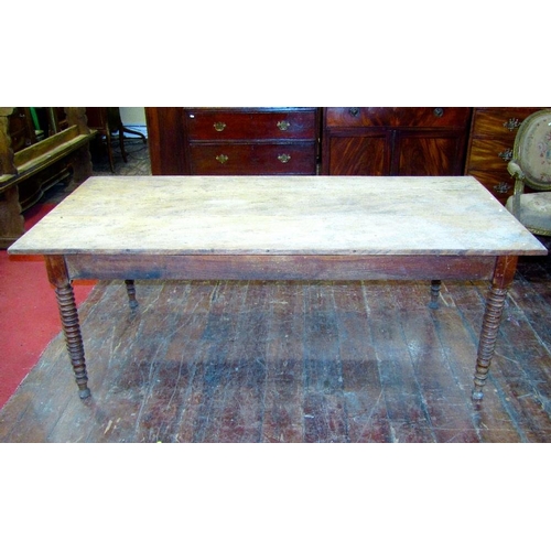 1512 - A 19th century elm farmhouse kitchen table,the plank top raised on four turned tapering bobbin suppo... 