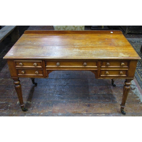 1514 - A Victorian satin walnut writing desk with five frieze drawers raised on fluted supports,122 cm wide