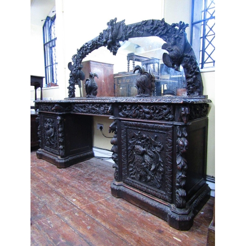 1521 - A remarkable Victorian carved oak pedestal sideboard with inverted breakfront form set beneath large... 