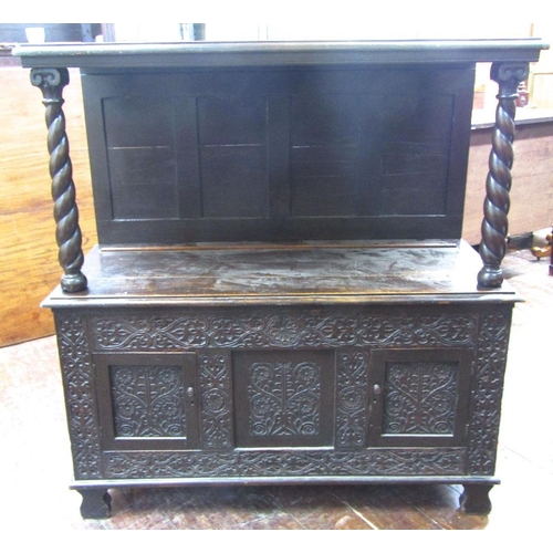 1527 - An old English oak buffet,the lower section enclosed by two doors with repeating carved floral and g... 