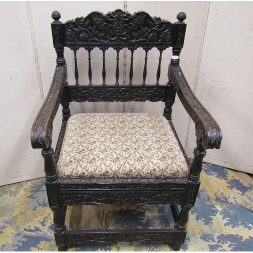 1528 - A good quality 19th century Indian ebonised hardwood elbow chair with drop in seat,profusely carved ... 