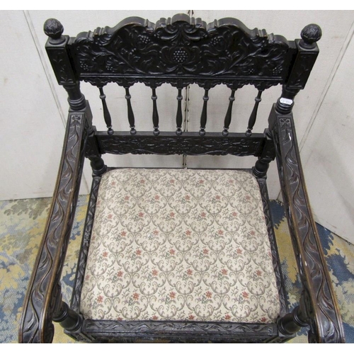 1528 - A good quality 19th century Indian ebonised hardwood elbow chair with drop in seat,profusely carved ... 