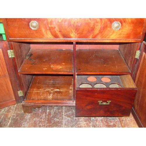 1531 - A Georgian mahogany cupboard enclosed by a frieze drawer and a pair of panelled doors raised on brac... 