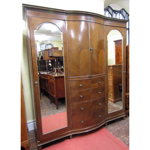 1534 - A substantial Edwardian mahogany triple wardrobe,the central section of bow-fronted outline,fitted w... 