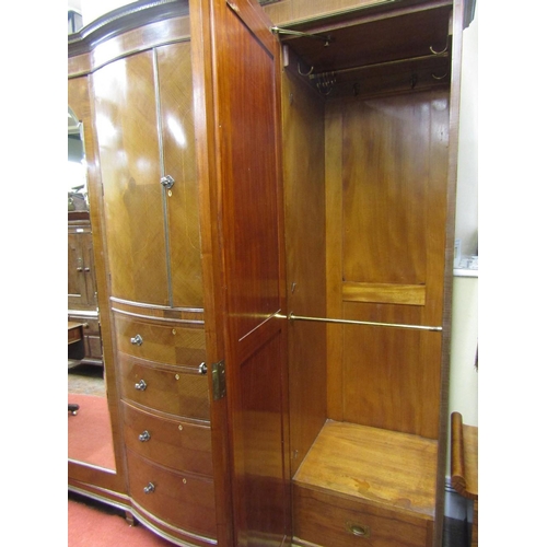 1534 - A substantial Edwardian mahogany triple wardrobe,the central section of bow-fronted outline,fitted w... 