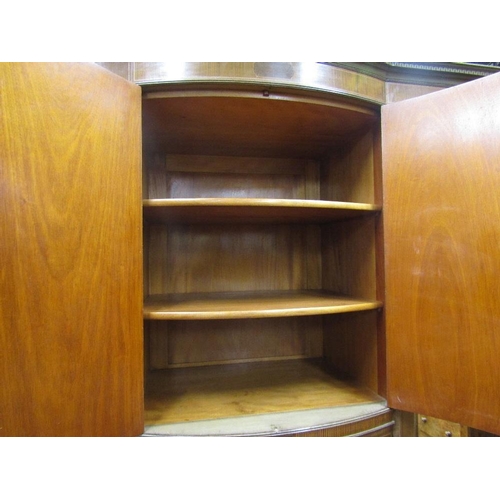 1534 - A substantial Edwardian mahogany triple wardrobe,the central section of bow-fronted outline,fitted w... 