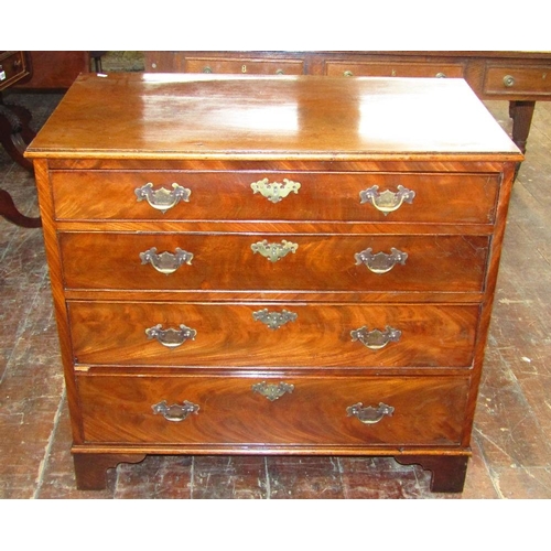 1538 - A small Georgian mahogany chest of four long graduated drawers with brass plate handles and escutche... 