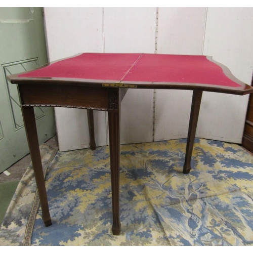 1541 - An Edwardian mahogany fold over top card table of serpentine form in a Georgian manner raised on squ... 