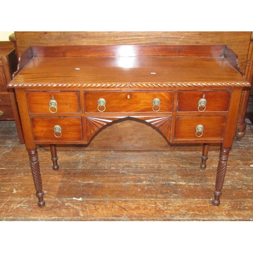 1544 - A Regency mahogany side table,with three quarter gallery,over an arrangement of five drawers and cen... 